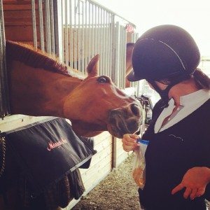 a rider and horse in a barn